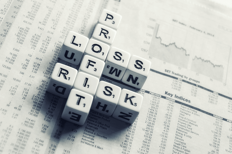 dices over newspaper spelling profit loss and risk