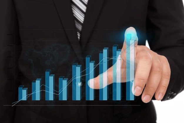 man touching a bar chart